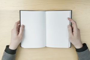 Man reading a blank book